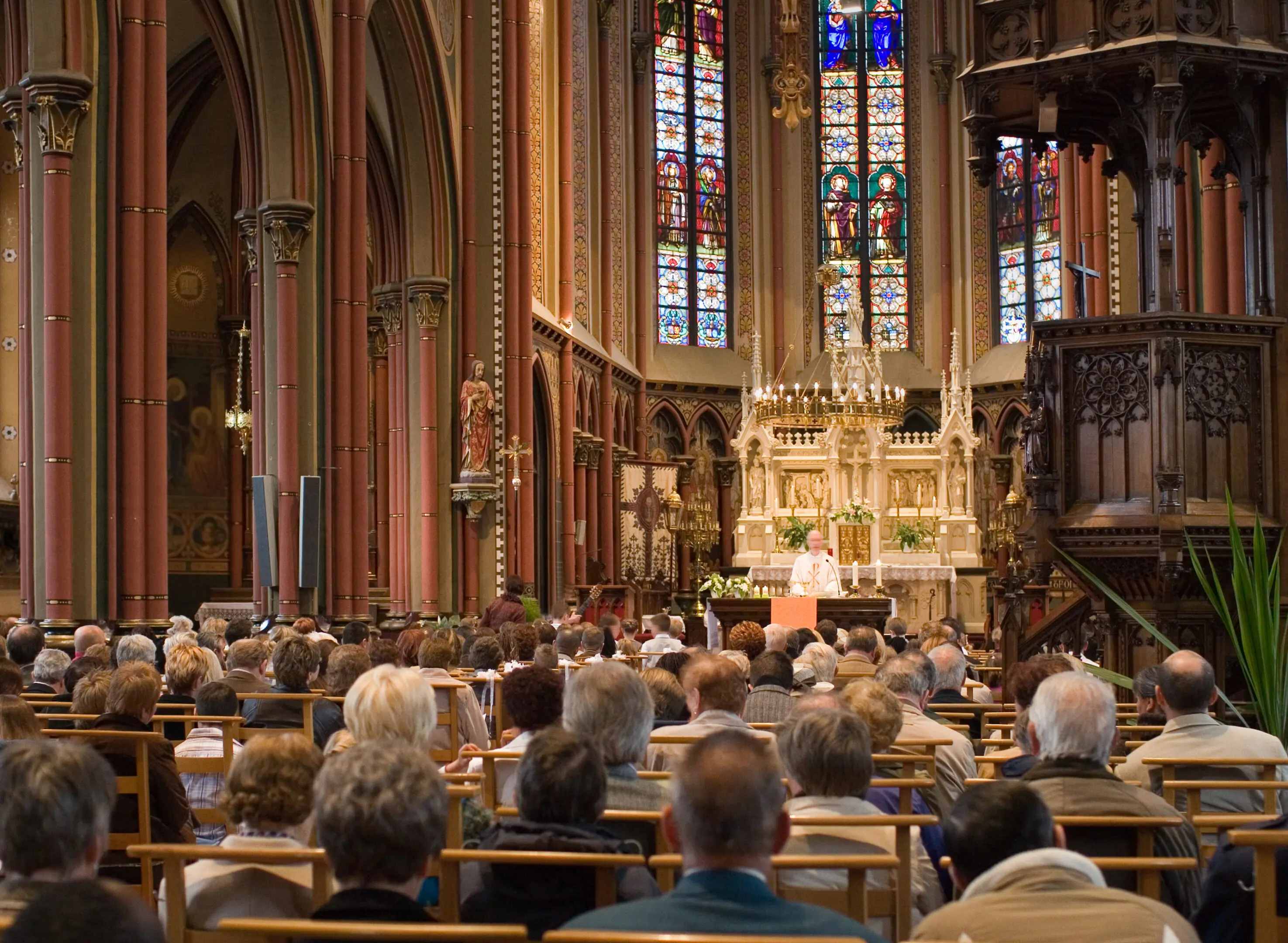 Congregation gathered inside a grand cathedral for a service.