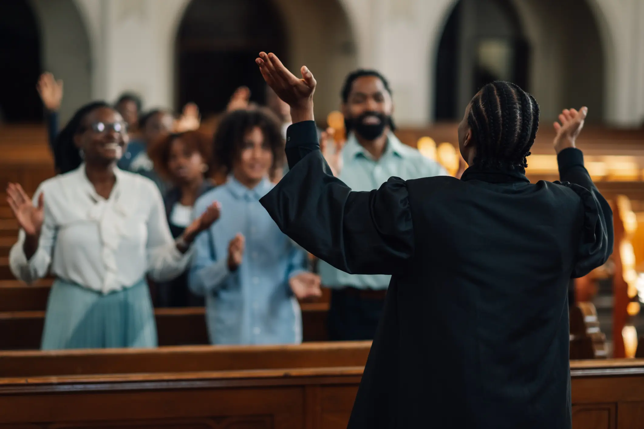 A person leads a group in worship at a church service.